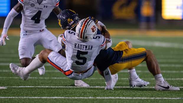 Sep 9, 2023; Berkeley, California, USA; California Golden Bears wide receiver Monroe Young (14) is tackled by Auburn Tigers safety Donovan Kaufman (5) during the second quarter at California Memorial Stadium. Mandatory Credit: Neville E. Guard-USA TODAY Sports  